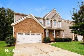 Denver house for rent - A brick house with a garage door that says Firstkey Homes.