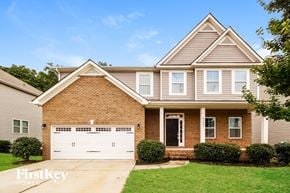 Denver house for rent - A brick house with a garage door that says "FirstKey Home".
