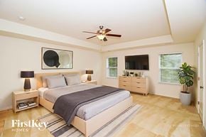 Denver house for rent - A bedroom with a bed, nightstands, and a ceiling fan.