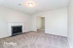 Lithonia house for rent - a living room with a fireplace and a carpeted floor