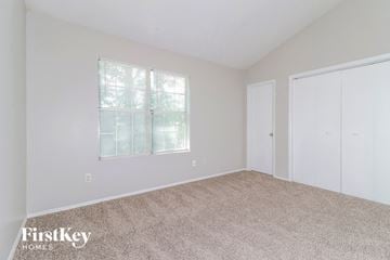 Lithonia house for rent - the living room of a home with carpet and a window