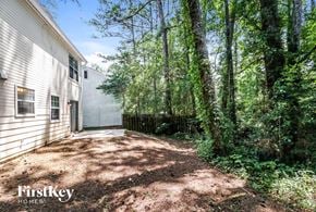 Lithonia house for rent - a backyard with trees and a white house