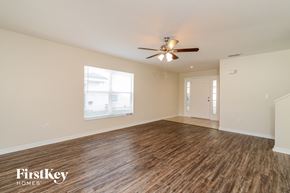 Lithia house for rent - A spacious room with wooden flooring and a ceiling fan.