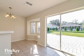 Lithia house for rent - A room with a sliding glass door leading to a backyard.