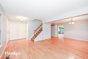 Florence house for rent - A spacious room with wooden flooring and a staircase leading to the upper level.