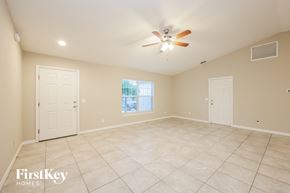Port Charlotte house for rent - A spacious room with a ceiling fan and tile flooring.