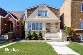 Chicago house for rent - a brick house with a front porch and stairs