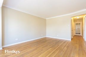 Chicago house for rent - the living room of a house with wooden floors and white walls