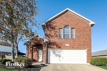 Fort Worth house for rent - a brick house with a white garage door