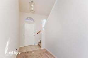 Fort Worth house for rent - a entryway with a white door and a carpeted staircase
