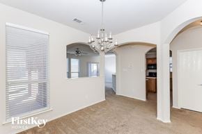 Fort Worth house for rent - a dining room with a chandelier and a large window
