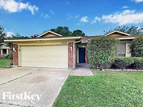 Arlington house for rent - a home with a garage door and a lawn