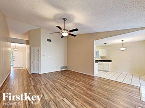 Arlington house for rent - an empty living room with wood flooring and a ceiling fan