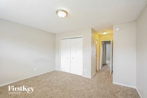 Indianapolis house for rent - A bedroom with a carpeted floor and a white ceiling.