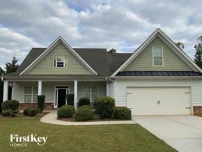 Flowery Branch house for rent - a house with a garage door and a lawn