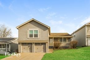 Kansas City house for rent - A house with a brown roof and a garage door is shown.