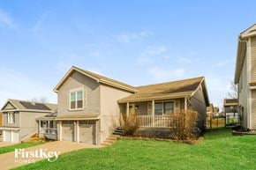 Kansas City house for rent - A house with a brown roof and a white garage door is for sale.