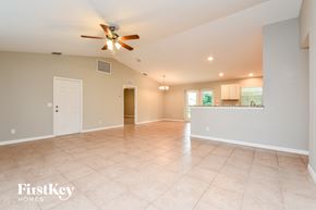 Englewood house for rent - A spacious room with a ceiling fan and tiled flooring.