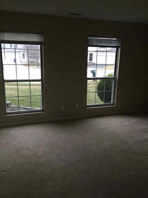 Galloway house for rent - an empty living room with two large windows