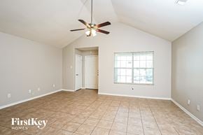 Katy house for rent - A spacious room with a ceiling fan and a window with blinds.