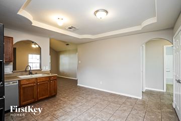 Katy house for rent - A kitchen with a sink and a refrigerator.