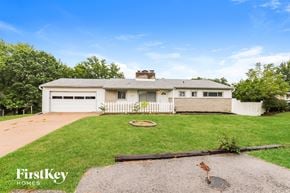 Kansas City house for rent - A house with a white picket fence is for sale.