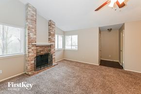 Houston house for rent - A room with a fireplace and a carpeted floor.