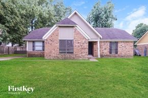 Memphis house for rent - A brick house with a grassy front yard.