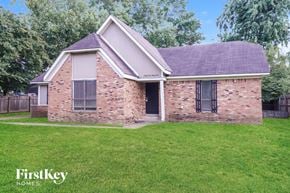 Memphis house for rent - A brick house with a black door and windows.