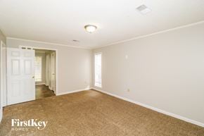 Memphis house for rent - A spacious room with a carpeted floor and a doorway leading to another room.