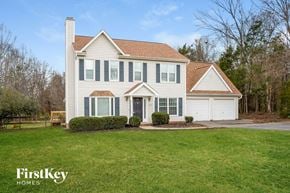 Clemmons house for rent - a white house with green shutters and a lawn