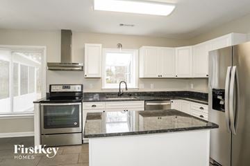 Clemmons house for rent - a white kitchen with granite counter tops and stainless steel appliances