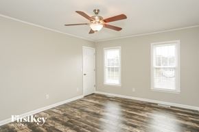 Clemmons house for rent - a living room with a ceiling fan and a door