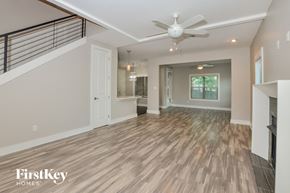 Olive Branch house for rent - A spacious room with wooden flooring and a ceiling fan.