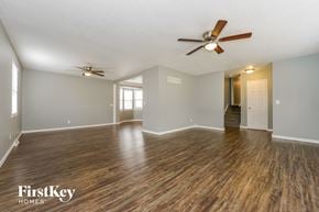 Kansas City house for rent - the living room and dining room with wood flooring and ceiling fans