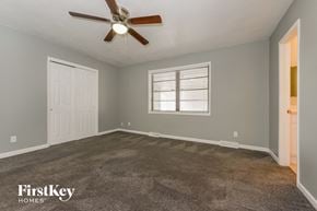 Kansas City house for rent - the master bedroom has a carpeted floor and a ceiling fan