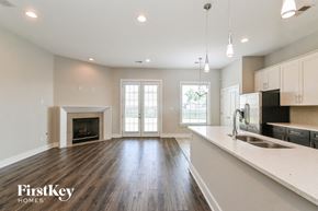Olive Branch house for rent - an open kitchen and living room with a fireplace