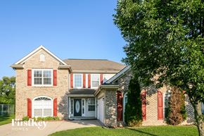 Indianapolis house for rent - a brick house with red shutters and a tree