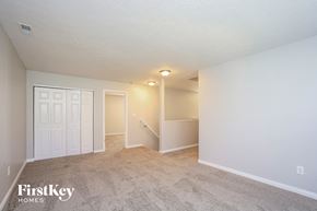 Indianapolis house for rent - a spacious living room with a carpeted floor and white walls