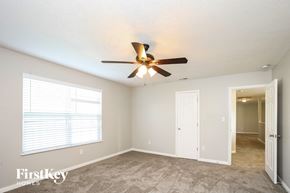 Indianapolis house for rent - a bedroom with a ceiling fan and a door to a closet