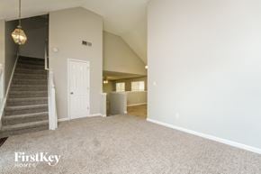 Lithonia house for rent - A spacious room with a staircase and a door in the background.