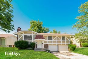Grandview house for rent - A house with a garage and a tree in front of it.