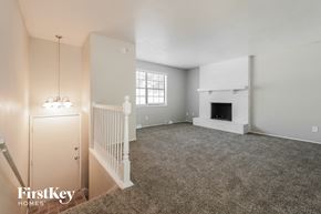 Grandview house for rent - A spacious living room with a fireplace and a carpeted floor.