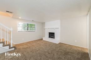 Grandview house for rent - A living room with a fireplace and a window.