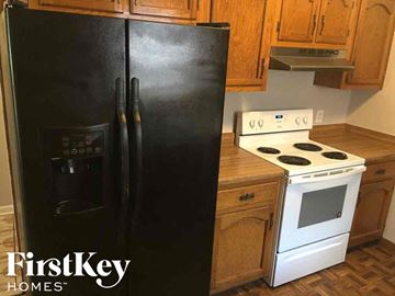 Memphis house for rent - a black refrigerator in a kitchen next to a stove and