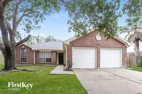 Katy house for rent - a brick house with a white garage door