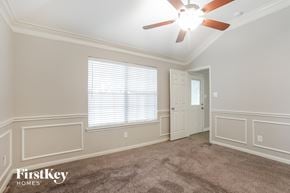 Katy house for rent - a living room with a ceiling fan and a white door