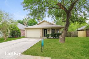 Katy house for rent - a small white house with a yard and a tree