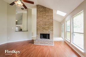 Katy house for rent - the living room has a brick fireplace and hardwood floors