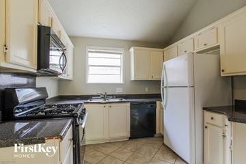 Katy house for rent - a kitchen with a stove refrigerator and sink